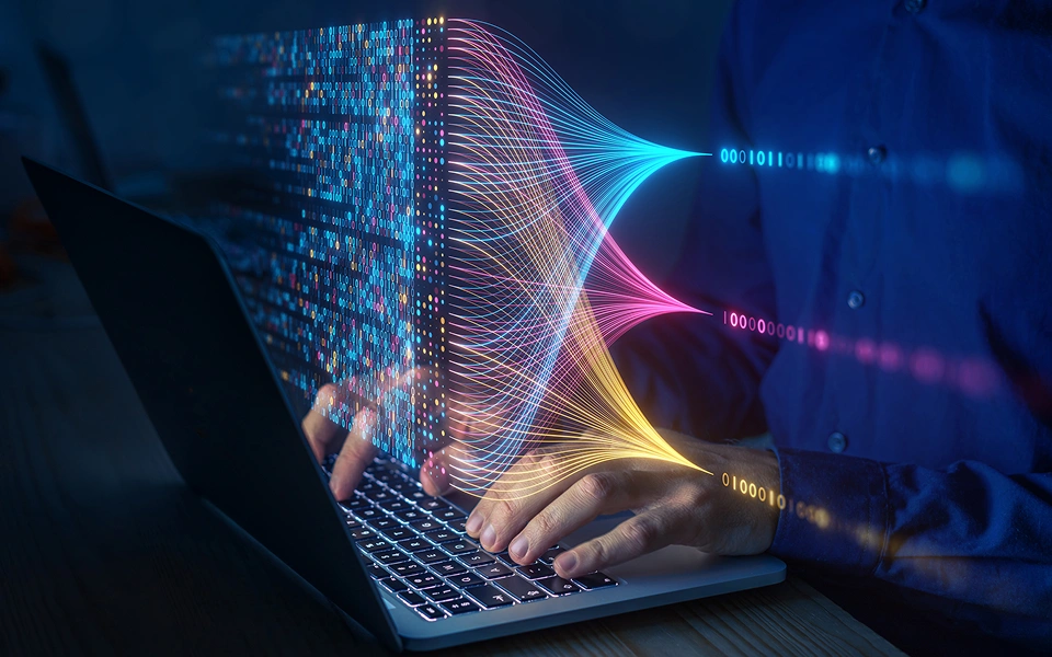 Person typing data with digital graphics overlay.
