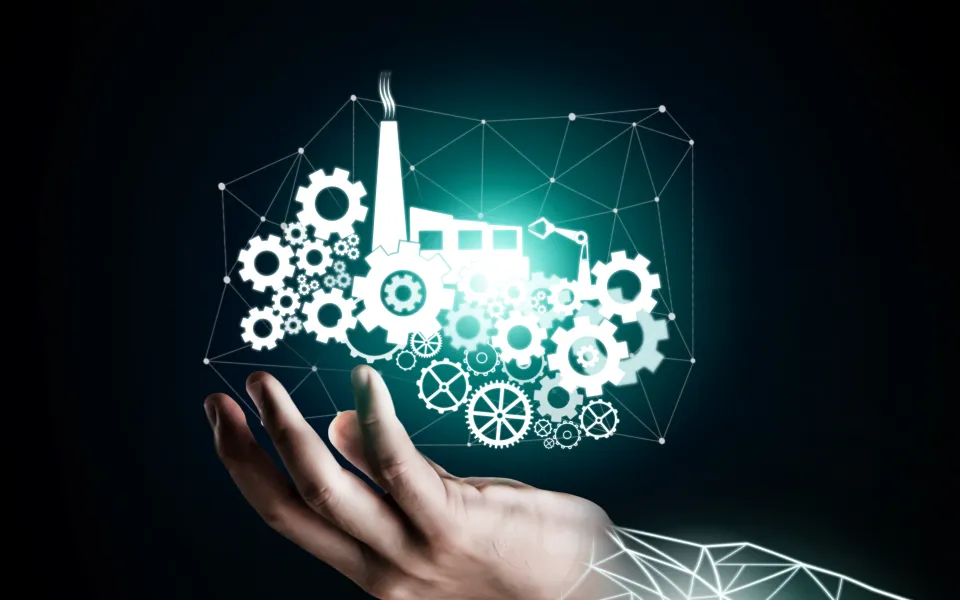 Hand holding holographic factory and gears network