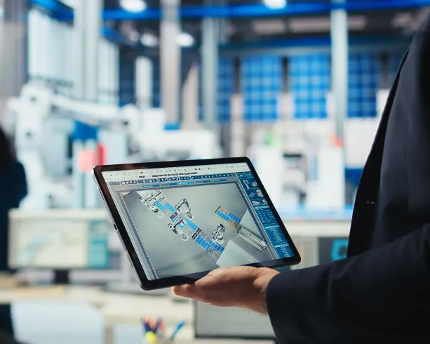 Engineer holding tablet with 3D factory model