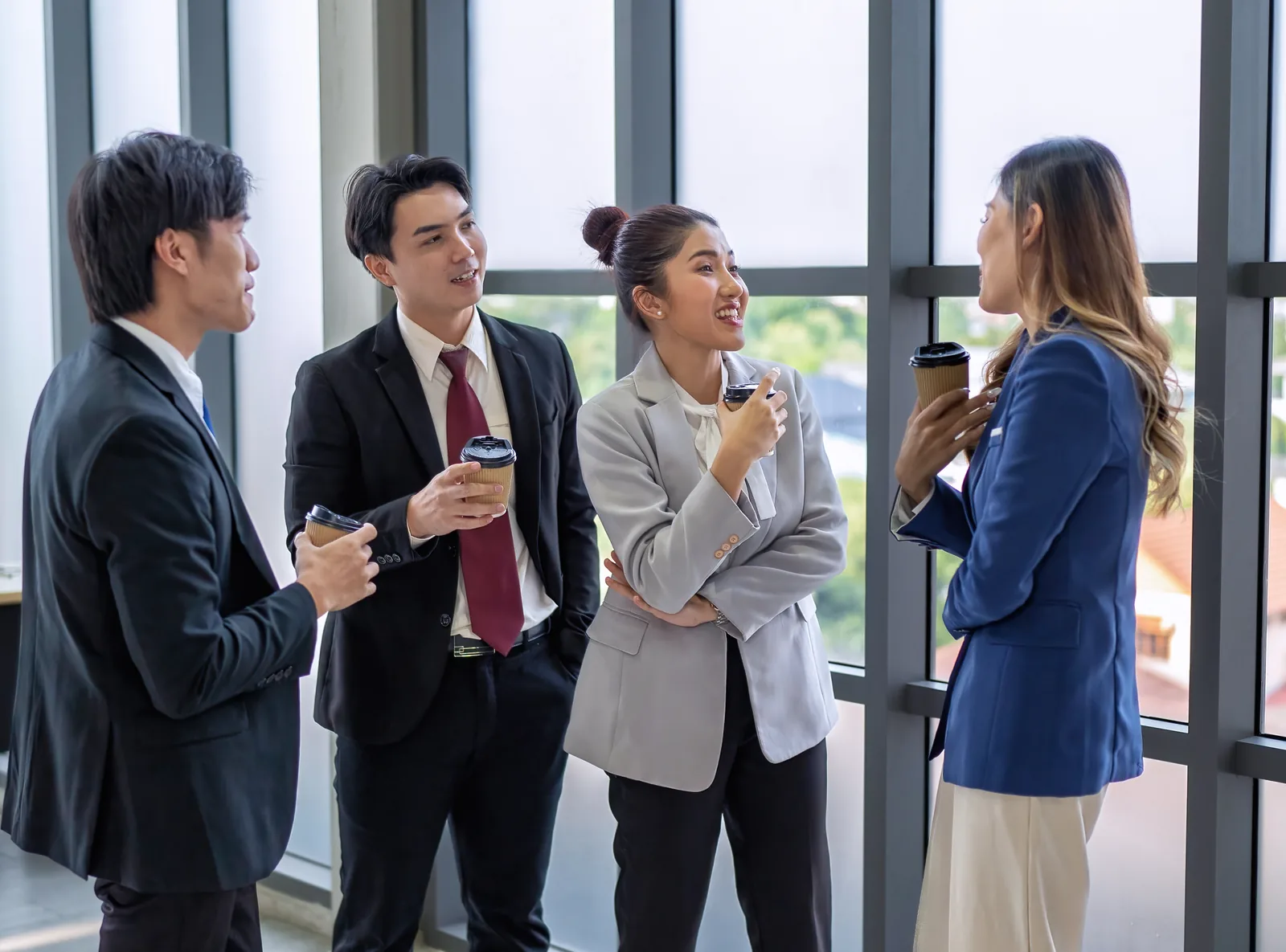 Professionals chatting over coffee during a break